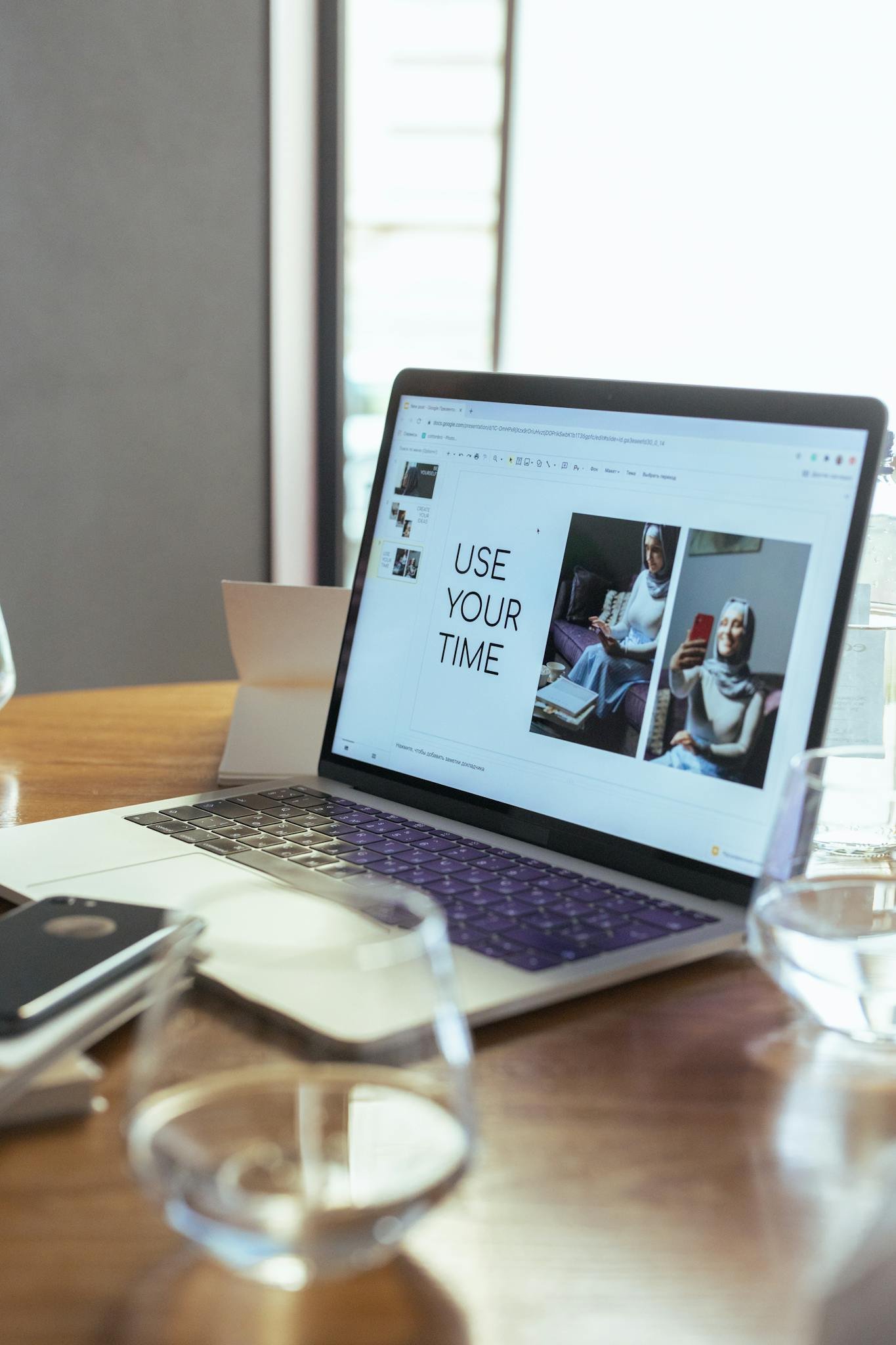 A laptop displaying a productivity presentation in a modern workspace.